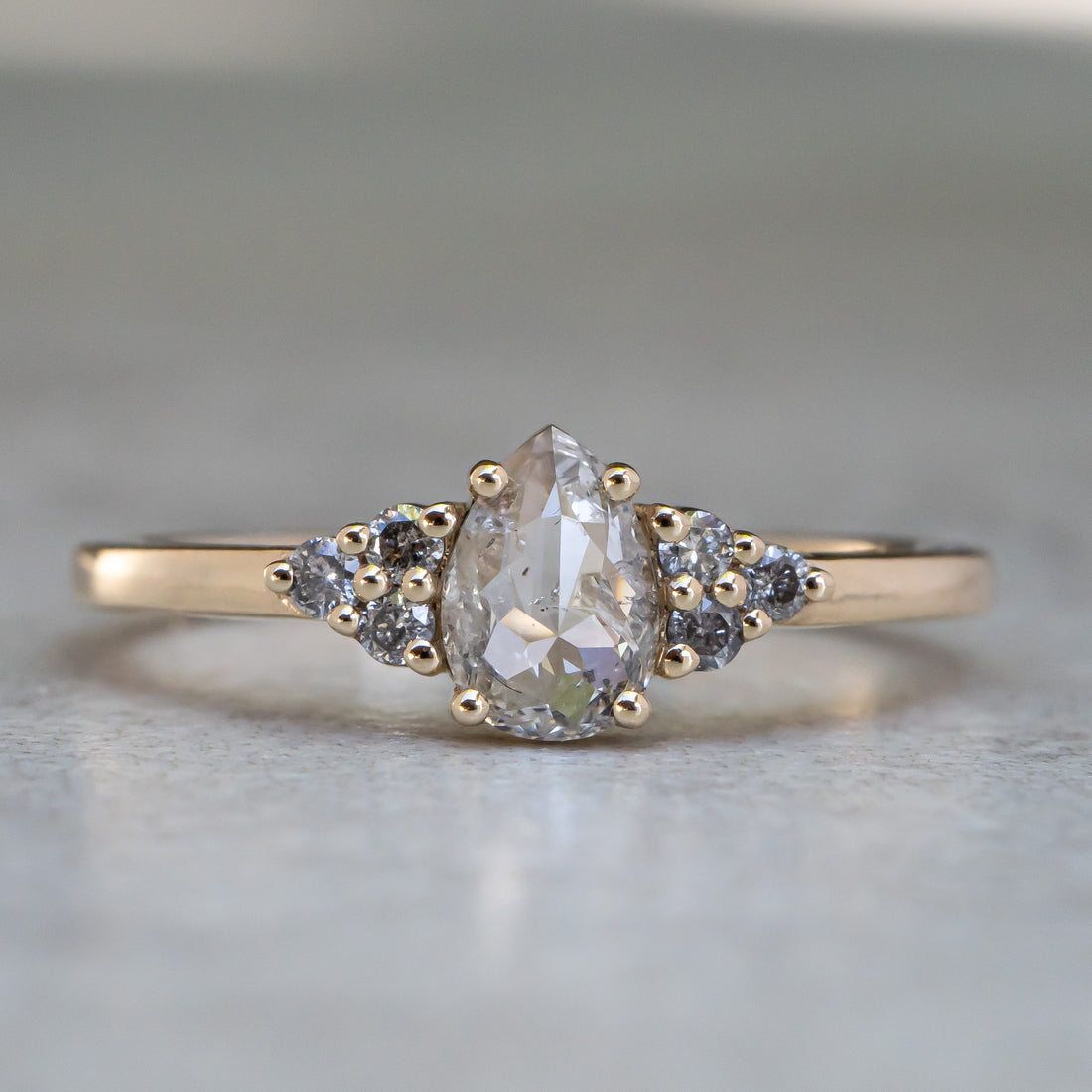 Icy White Pear Diamond Ring with Cluster Accents